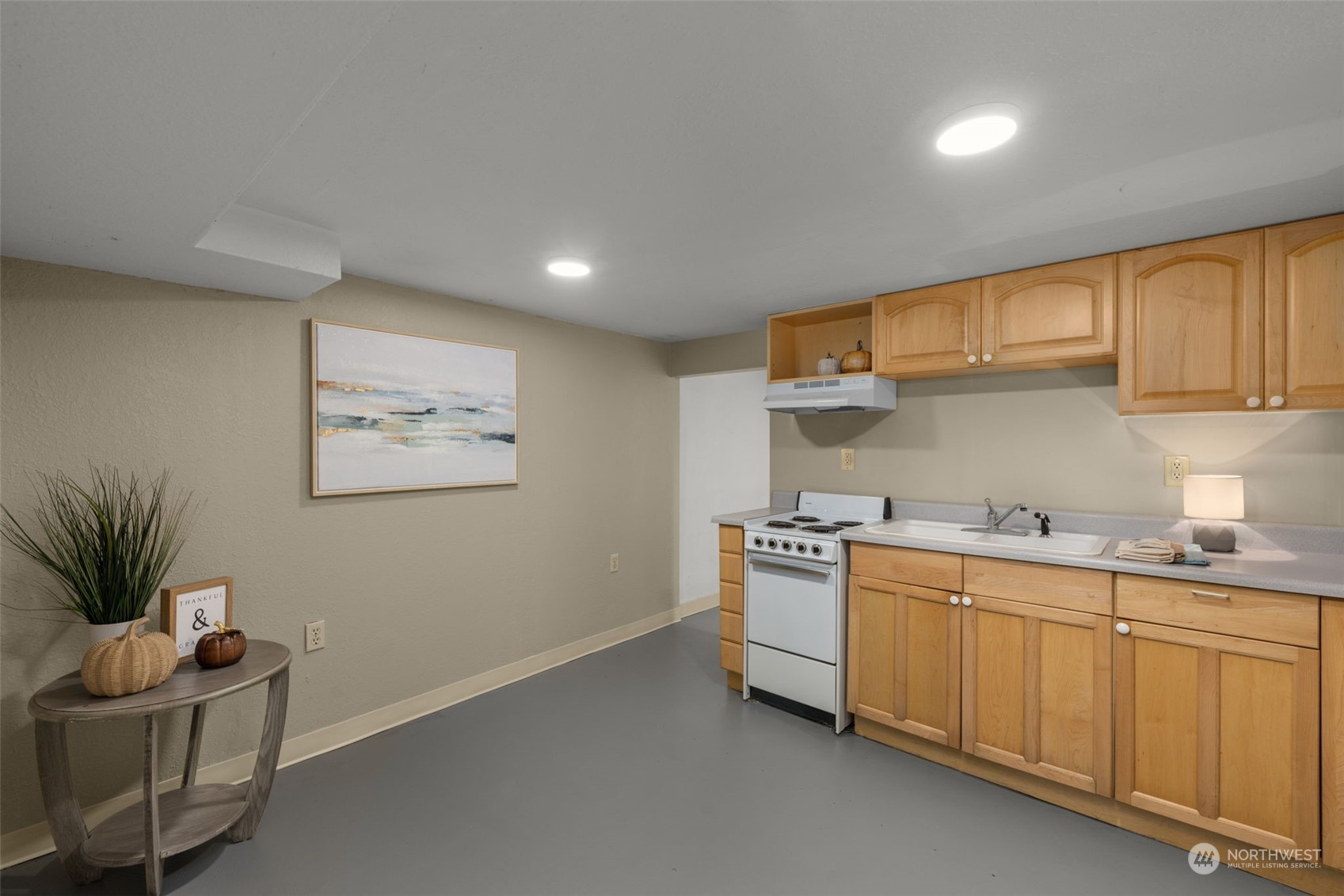 17547 Southeast 135th Street Renton, WA 98059 - Photo 27 of 37 a kitchen with stainless steel appliances a sink a stove a chimney a refrigerator and cabinets