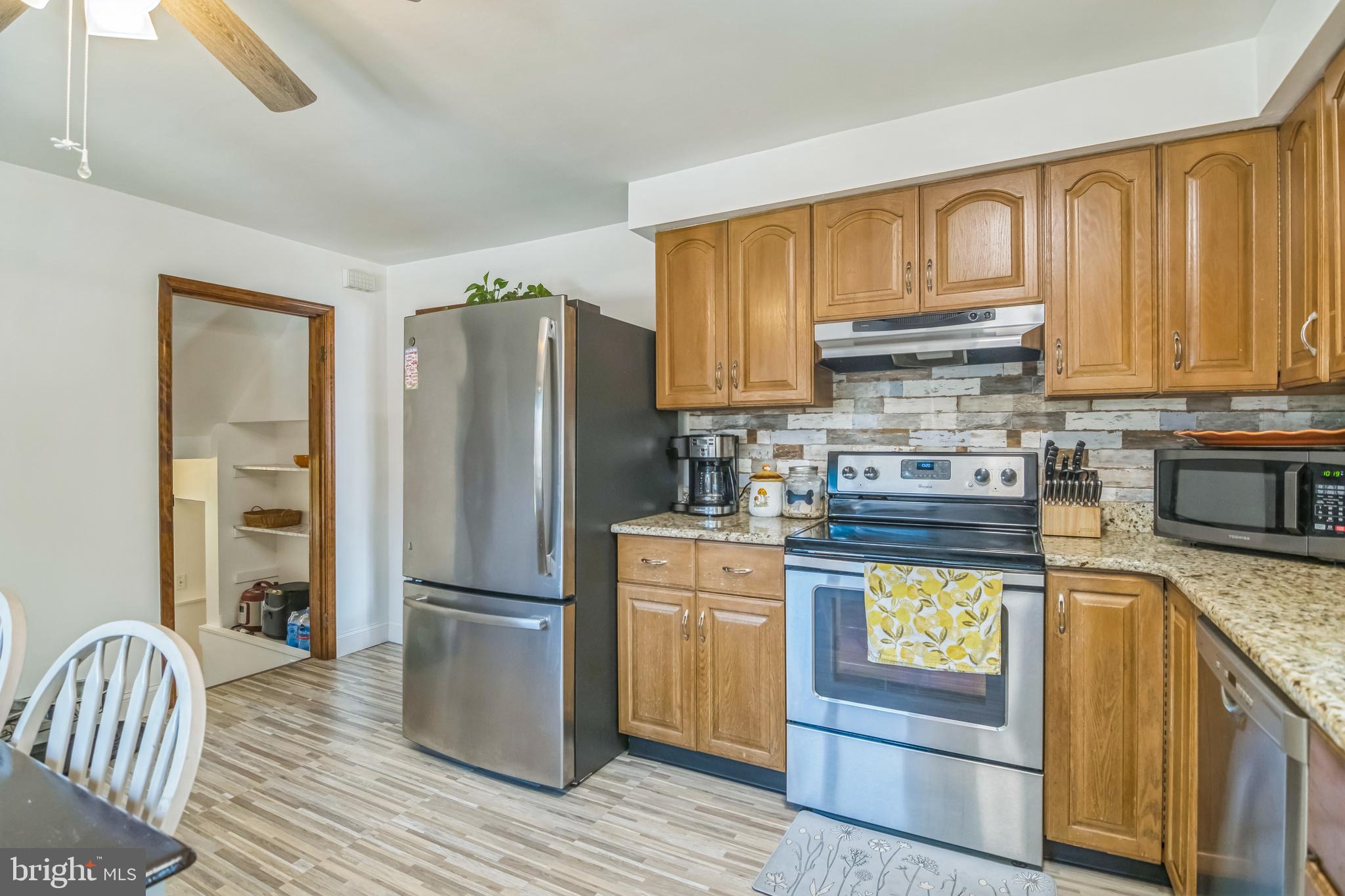 361 Amosland Road Holmes, PA 19043 - Photo 16 of 30 a kitchen with a refrigerator and a stove top oven