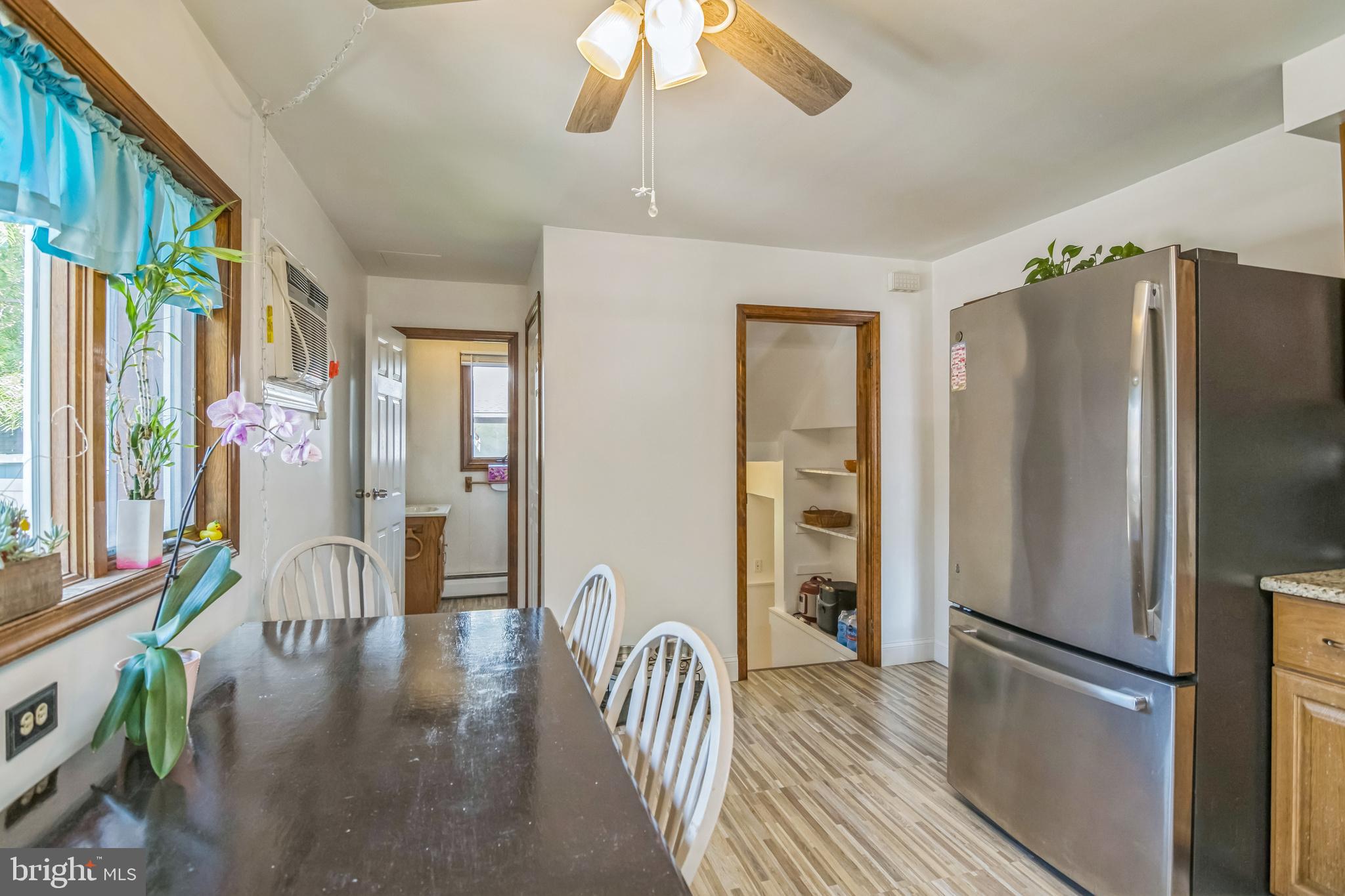 361 Amosland Road Holmes, PA 19043 - Photo 18 of 30 a kitchen with stainless steel appliances granite countertop a refrigerator a stove a sink and a dining table with wooden floor