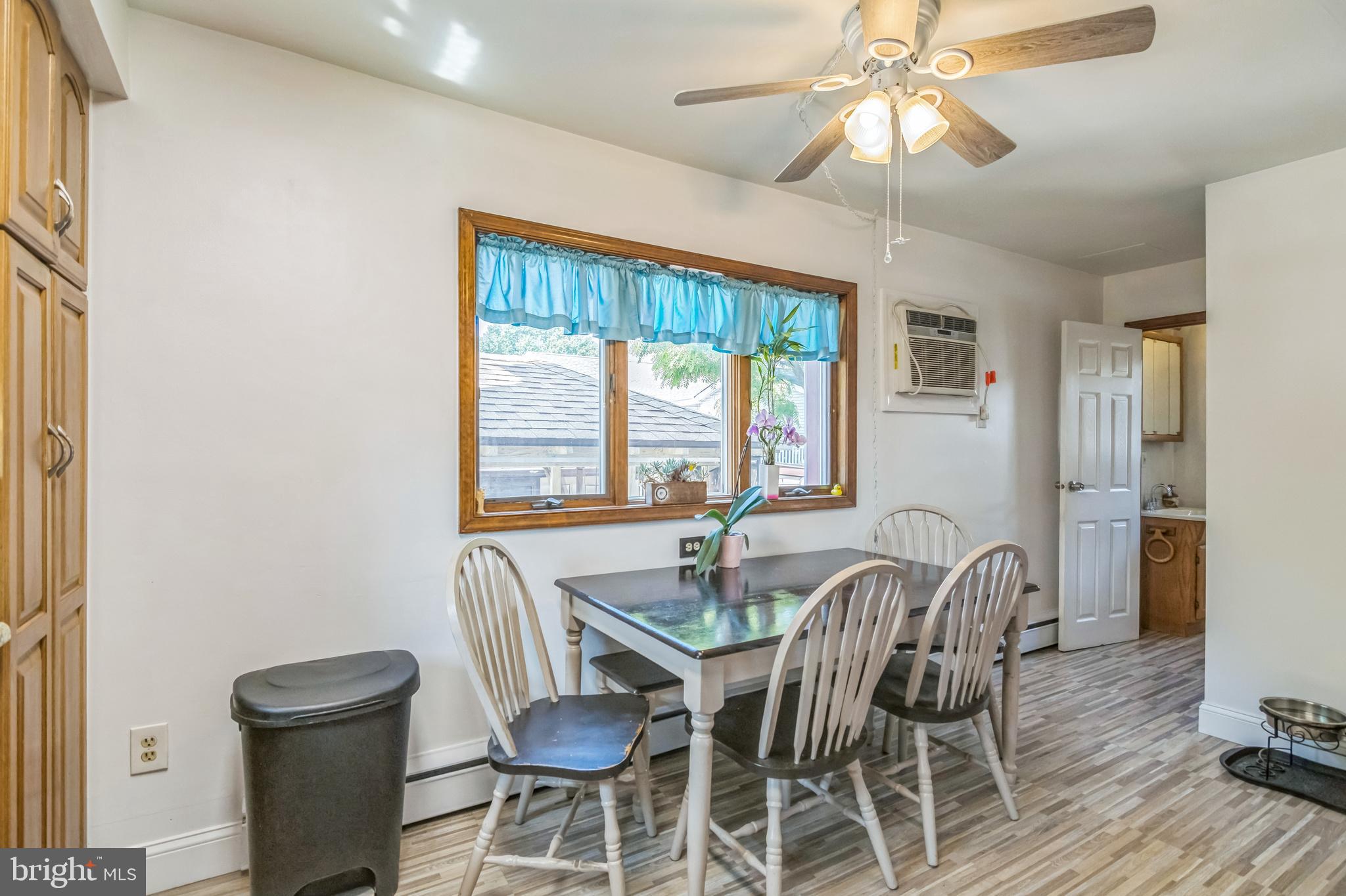 361 Amosland Road Holmes, PA 19043 - Photo 19 of 30 a dining room with furniture a chandelier and wooden floor