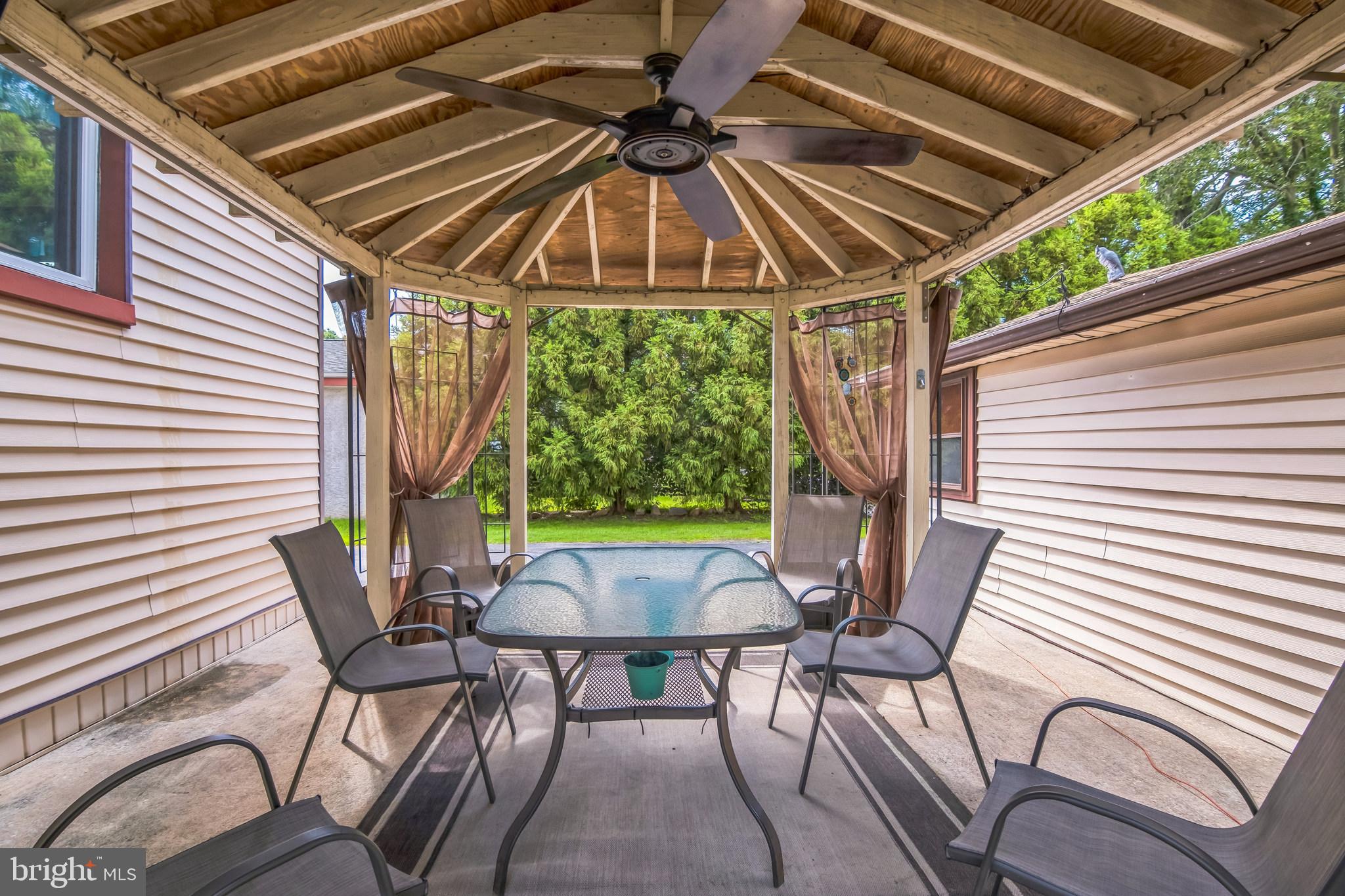 361 Amosland Road Holmes, PA 19043 - Photo 8 of 30 a patio with yard glass top table and chairs