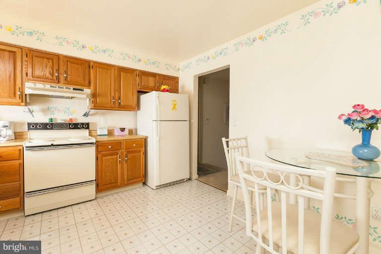 2001 Middleborough Road Baltimore, MD 21221 - Photo 8 of 30 a kitchen with a refrigerator a stove top oven and cabinets
