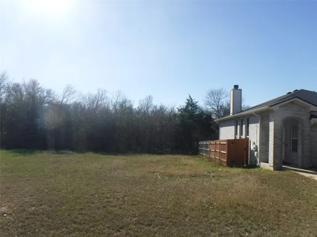 a view of a house with a yard and a large window