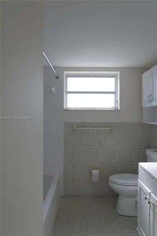 a bathroom with a sink a toilet and bathtub