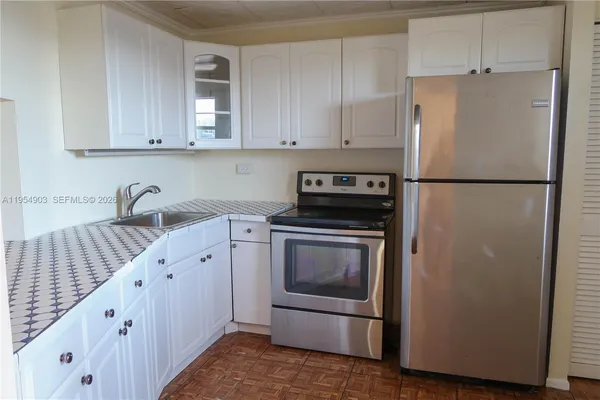 a white refrigerator freezer sitting inside of a kitchen