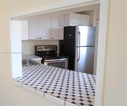 a kitchen with a refrigerator and a stove
