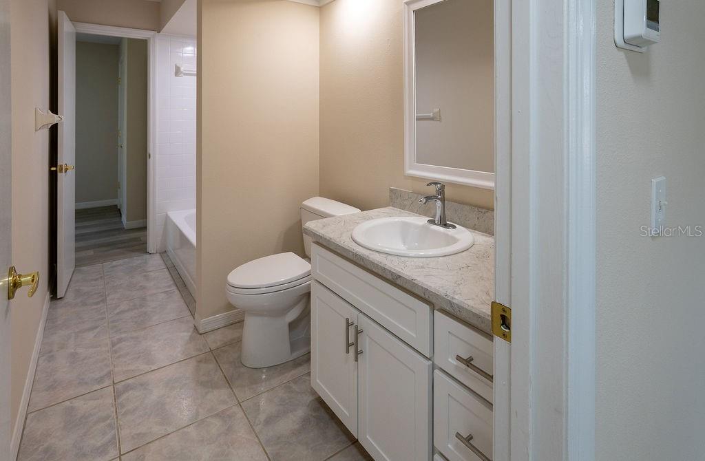 2405 Timbercreek Loop East Lakeland, FL 33805 - Photo 19 of 48 a bathroom with a sink a toilet and a mirror