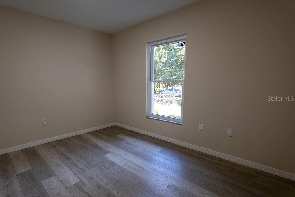 2405 Timbercreek Loop East Lakeland, FL 33805 - Photo 27 of 48 an empty room with wooden floor and windows