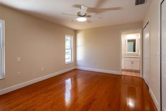 wooden floor in an empty room with a window