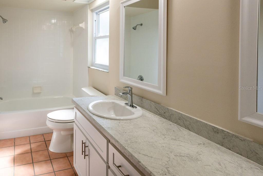 2405 Timbercreek Loop East Lakeland, FL 33805 - Photo 35 of 48 a bathroom with a granite countertop sink a toilet and a bathtub