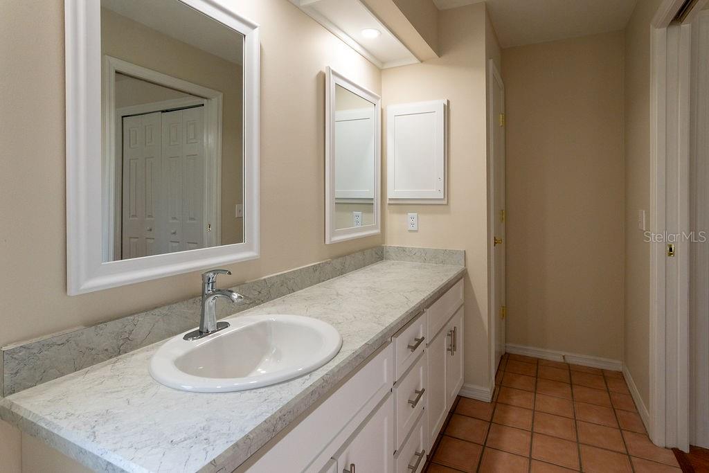 2405 Timbercreek Loop East Lakeland, FL 33805 - Photo 36 of 48 a bathroom with a granite countertop sink and a mirror