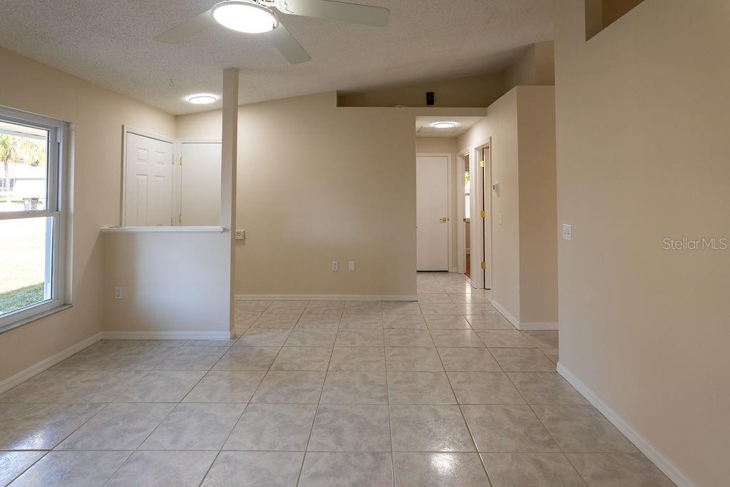 2405 Timbercreek Loop East Lakeland, FL 33805 - Photo 5 of 48 a view of an empty room and window and chandelier fan