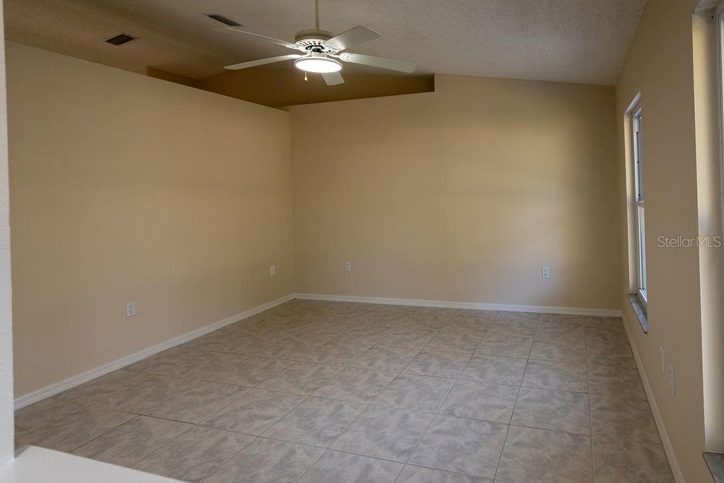 2405 Timbercreek Loop East Lakeland, FL 33805 - Photo 6 of 48 an empty room with a chandelier fan and a chandelier fan