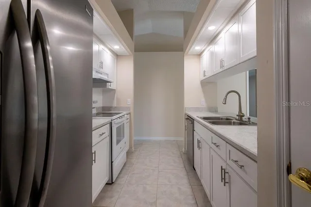 a kitchen with stainless steel appliances granite countertop a sink and stove