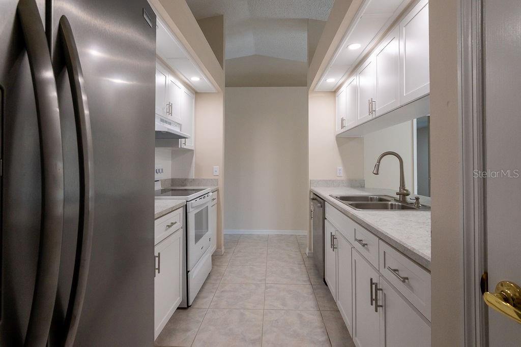 2405 Timbercreek Loop East Lakeland, FL 33805 - Photo 9 of 48 a kitchen with stainless steel appliances granite countertop a sink and stove