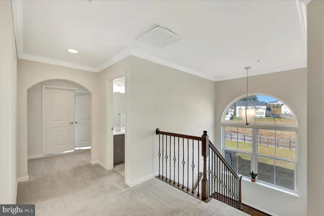 a bedroom with a bed couch and a large window
