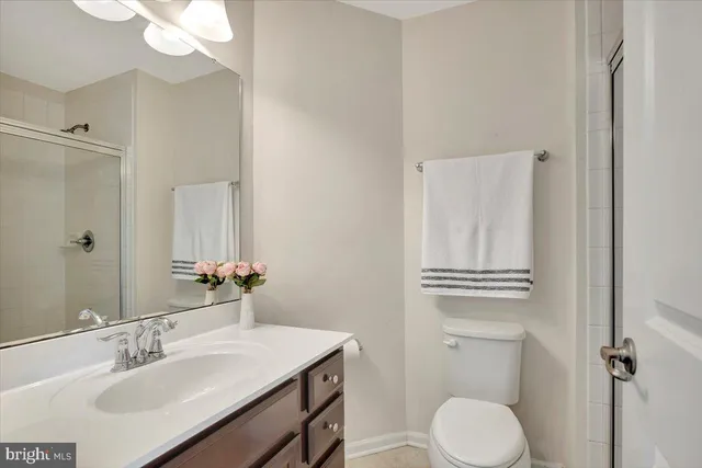 a bedroom with bed and a potted plant