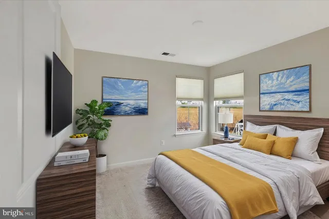 a spacious bedroom with a large bed and a flat screen tv