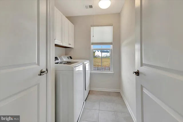 a bathroom with a double vanity sink mirror and toilet
