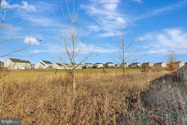 a view of a white house with a yard