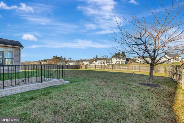 a view of a yard with a house in the background