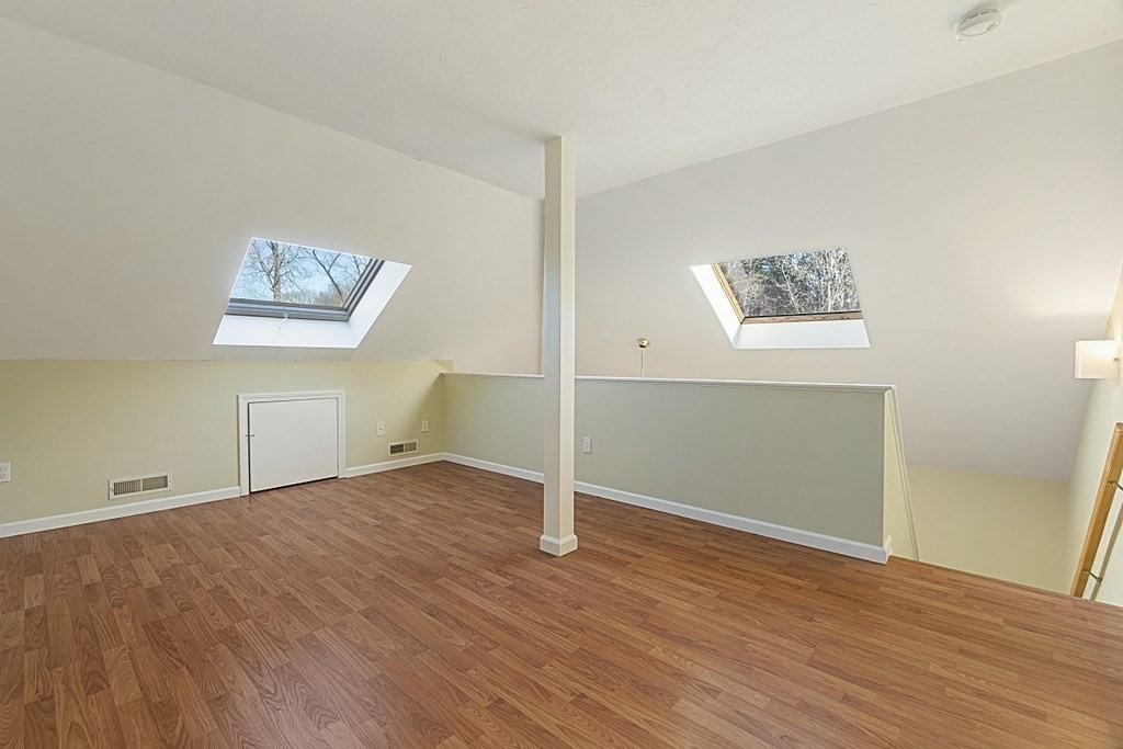 360 Littleton Road, Unit F2 Chelmsford, MA 01824 - Photo 15 of 27 an empty room with wooden floor and windows