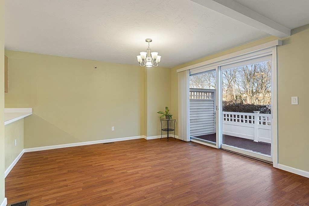 360 Littleton Road, Unit F2 Chelmsford, MA 01824 - Photo 5 of 27 a view of an empty room with wooden floor and a window