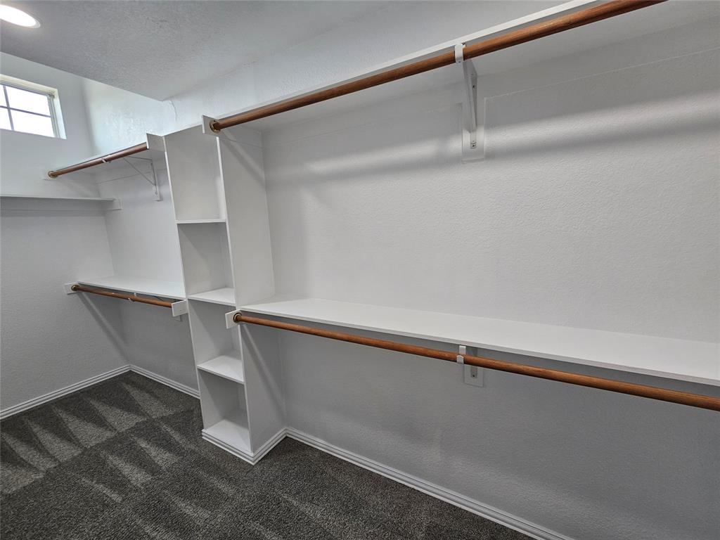 207 Starr Street Dallas, TX 75203 - Photo 14 of 28 Walk in closet with dark colored carpet