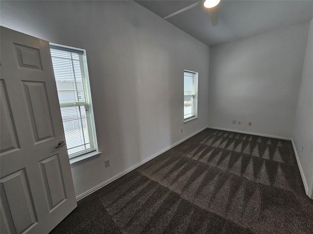 207 Starr Street Dallas, TX 75203 - Photo 20 of 28 Unfurnished room featuring ceiling fan and dark carpet