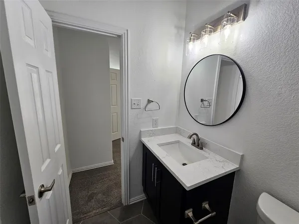 a white toilet and tub sitting next to a bathroom sink