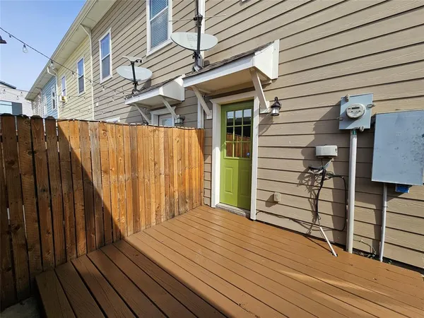 a view of backyard with wooden fence and large trees