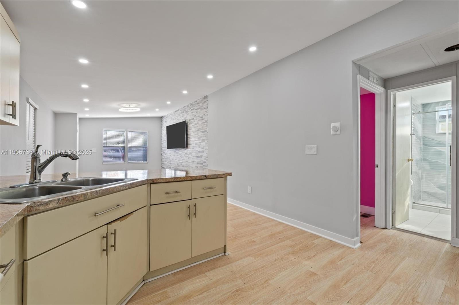 5305 Northwest 202nd Terrace Miami Gardens, FL 33055 - Photo 11 of 40 a view of cabinets a sink wooden floor and a living room
