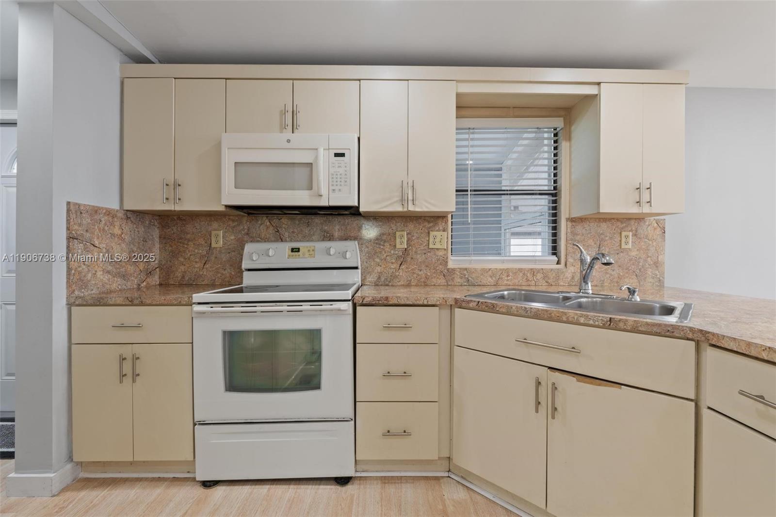 5305 Northwest 202nd Terrace Miami Gardens, FL 33055 - Photo 12 of 40 a kitchen with cabinets appliances a sink and a window