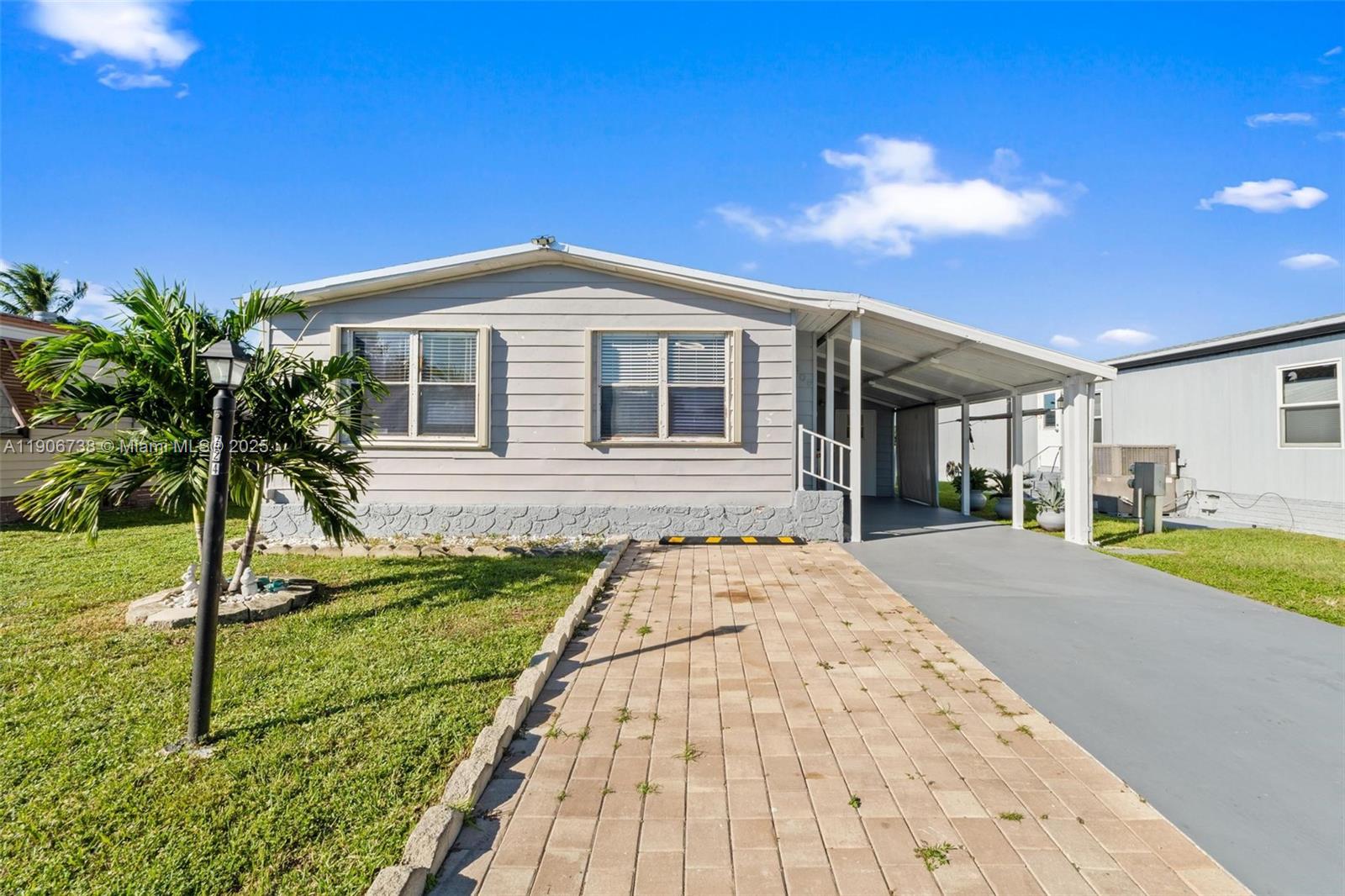 5305 Northwest 202nd Terrace Miami Gardens, FL 33055 - Photo 4 of 40 a front view of a house with a yard