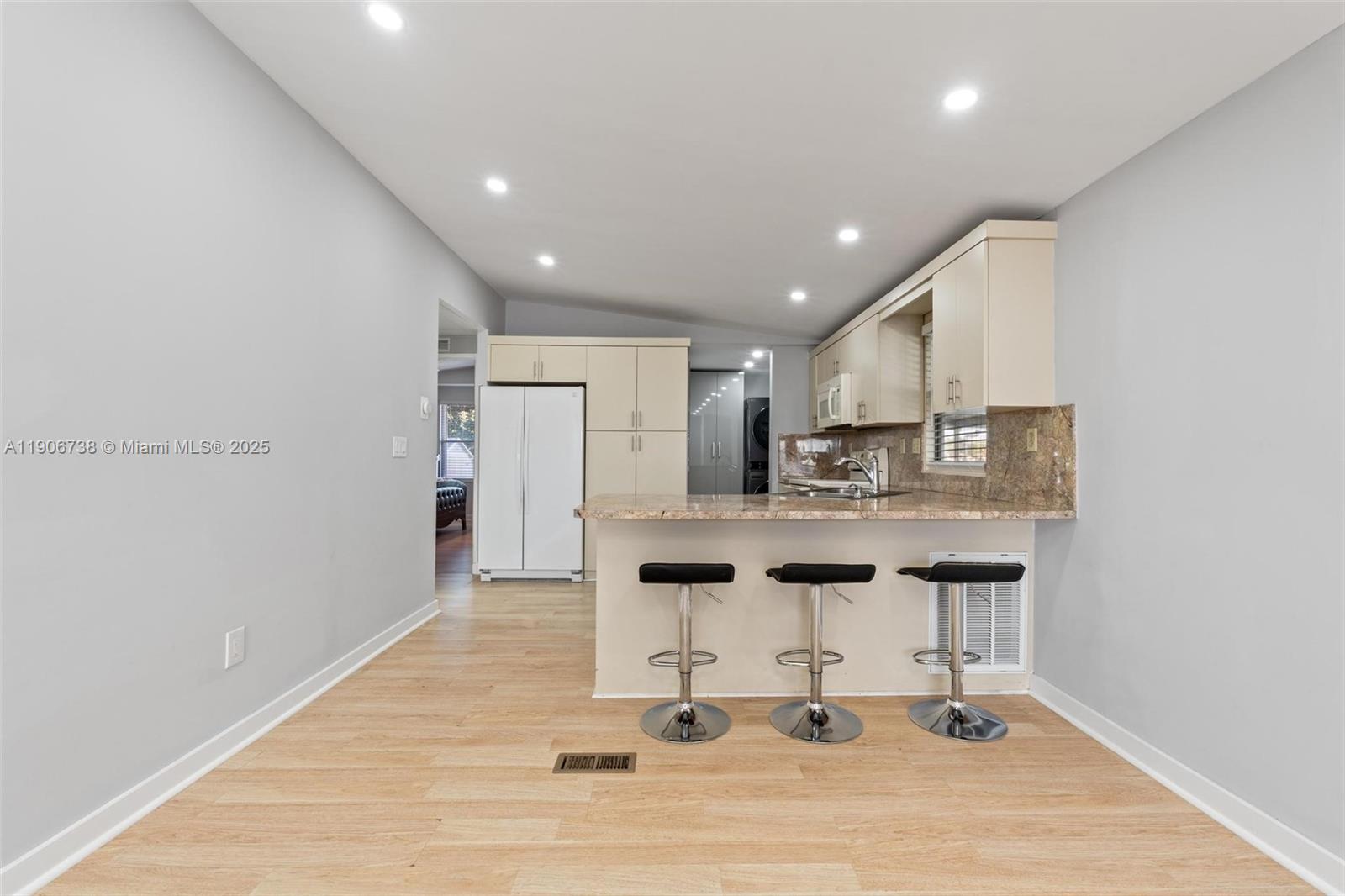 5305 Northwest 202nd Terrace Miami Gardens, FL 33055 - Photo 9 of 40 a kitchen with stainless steel appliances kitchen island hardwood floor and sink