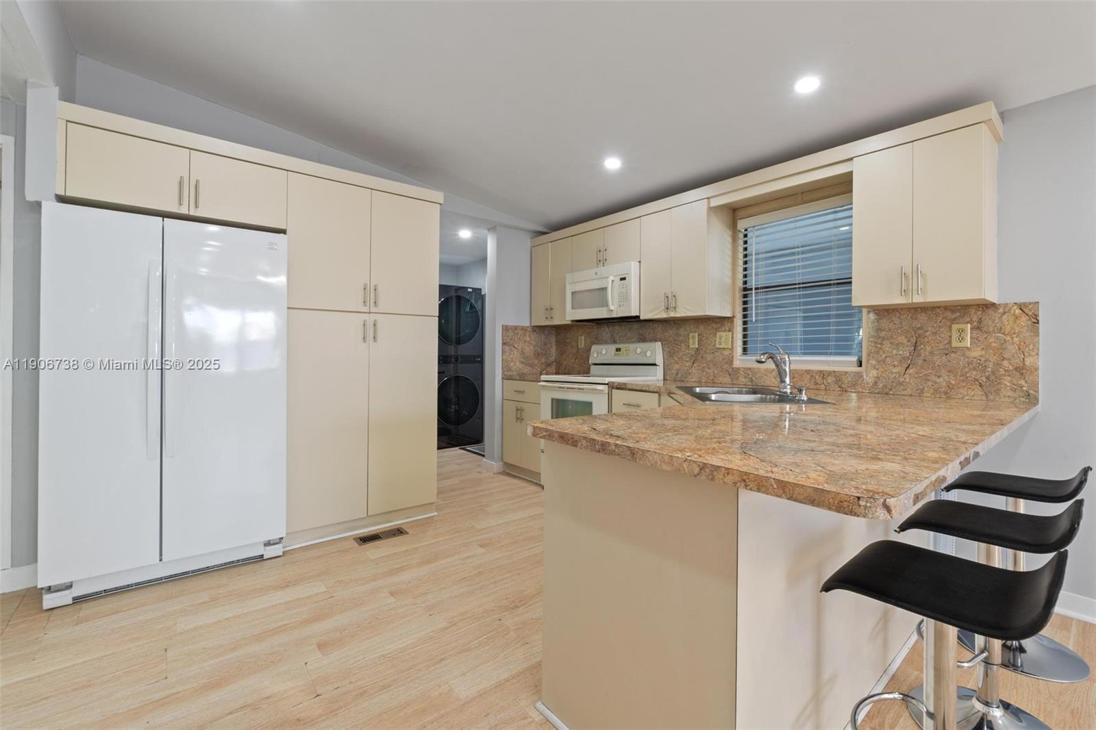 5305 Northwest 202nd Terrace Miami Gardens, FL 33055 - Photo 10 of 40 a kitchen with stainless steel appliances granite countertop a refrigerator and a sink