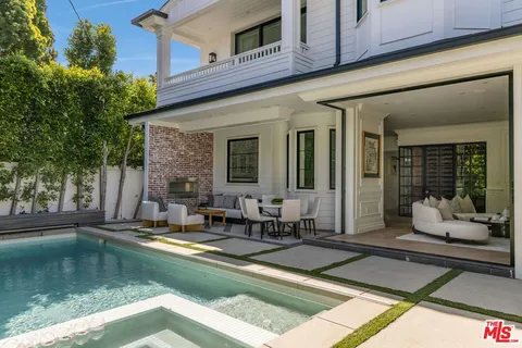 a view of a house with swimming pool and sitting area