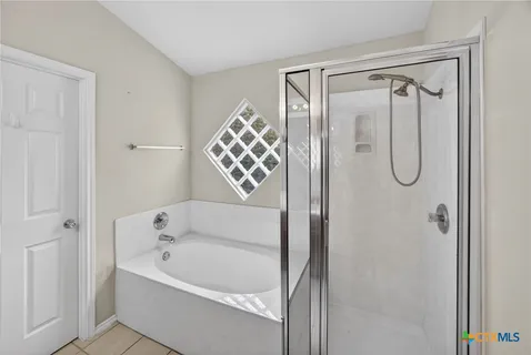 a bathroom with a bathtub shower and a sink
