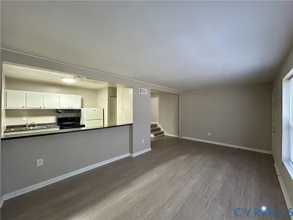 an empty room with wooden floor and view