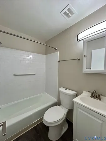 a white toilet sitting next to a bath tub