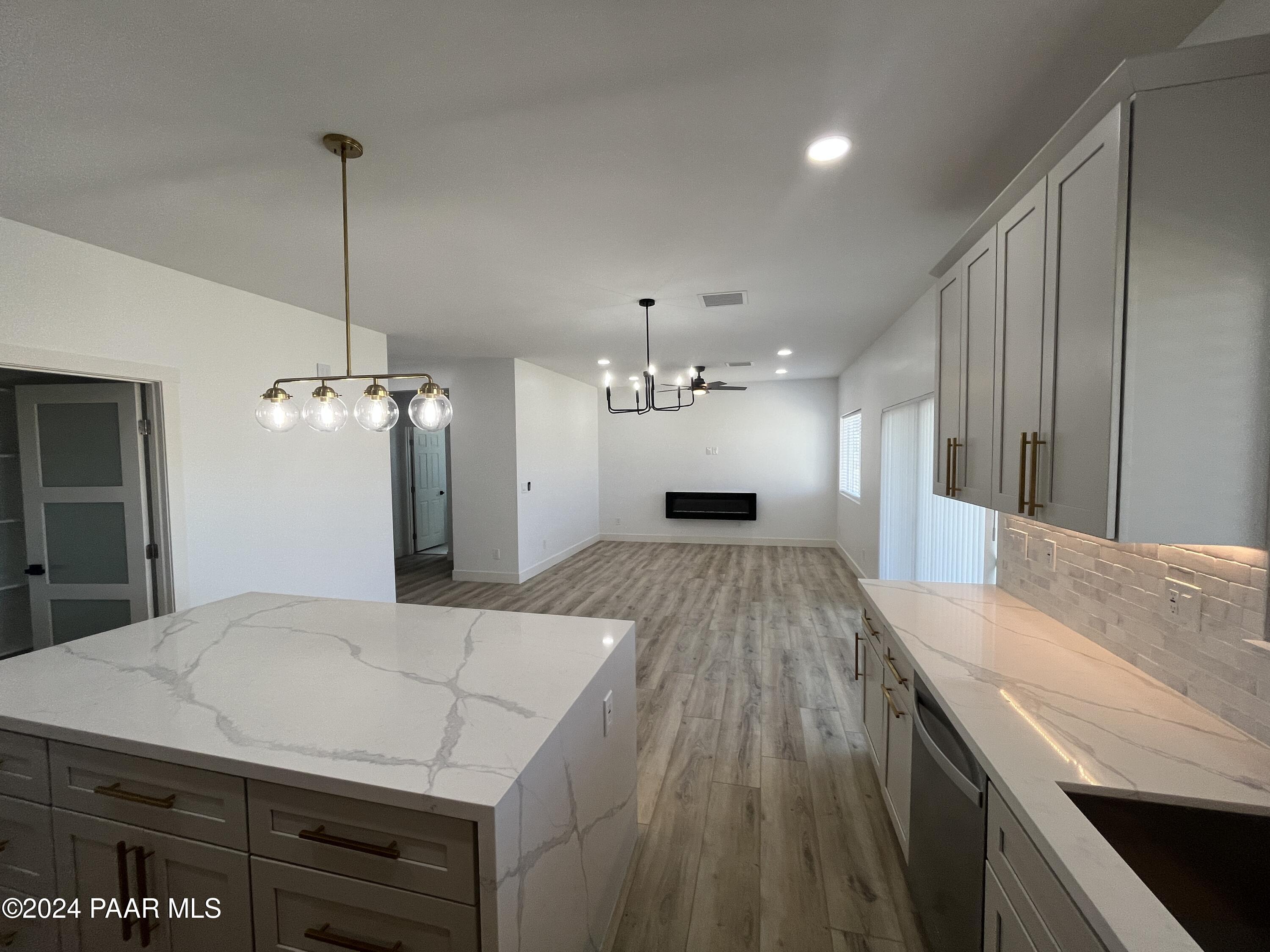 15630 Oasis Drive Mayer, AZ 86333 - Photo 12 of 29 a open kitchen with kitchen island a sink stove and wooden floor