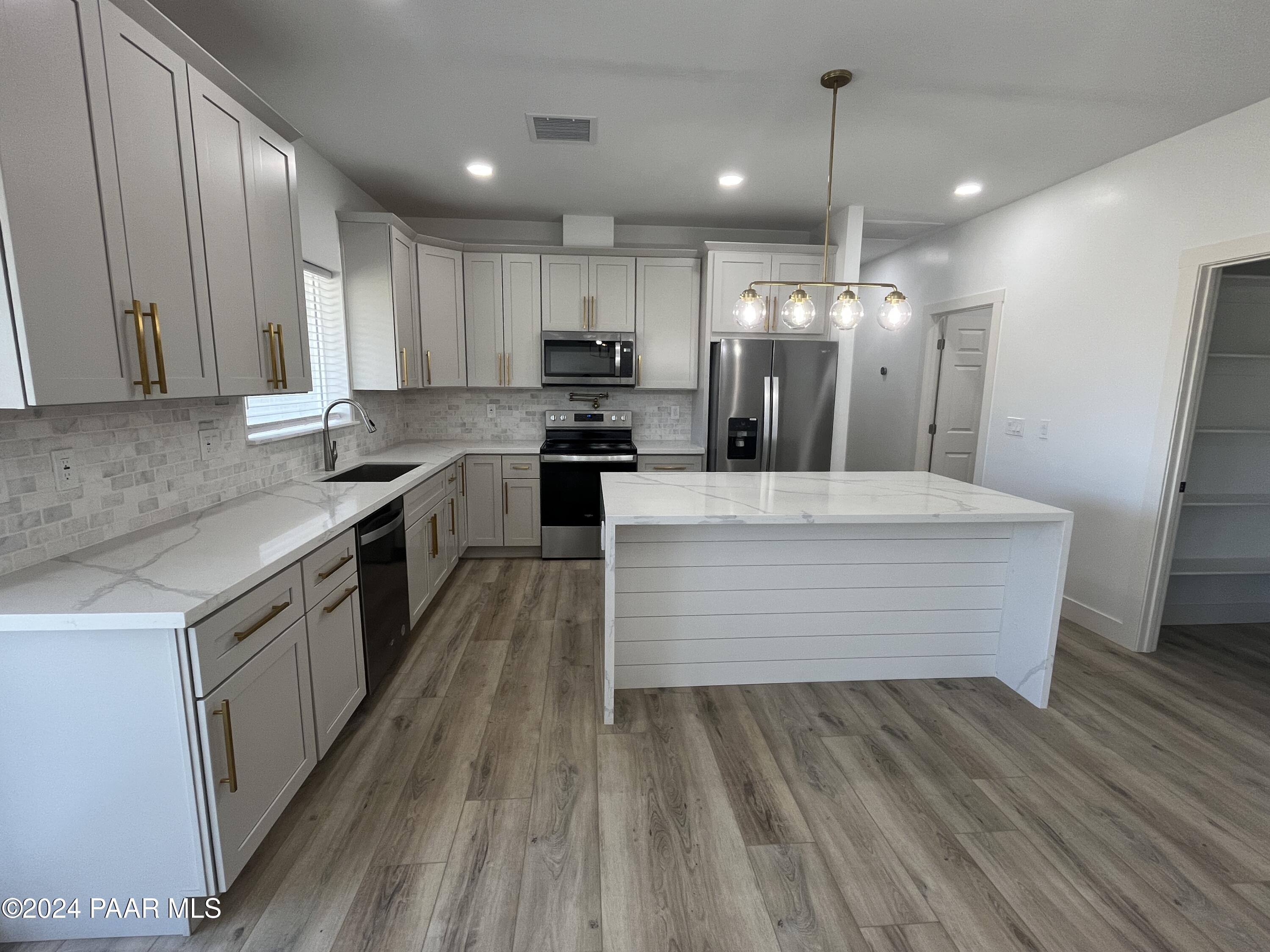 15630 Oasis Drive Mayer, AZ 86333 - Photo 16 of 29 a large kitchen with kitchen island a large island in the center