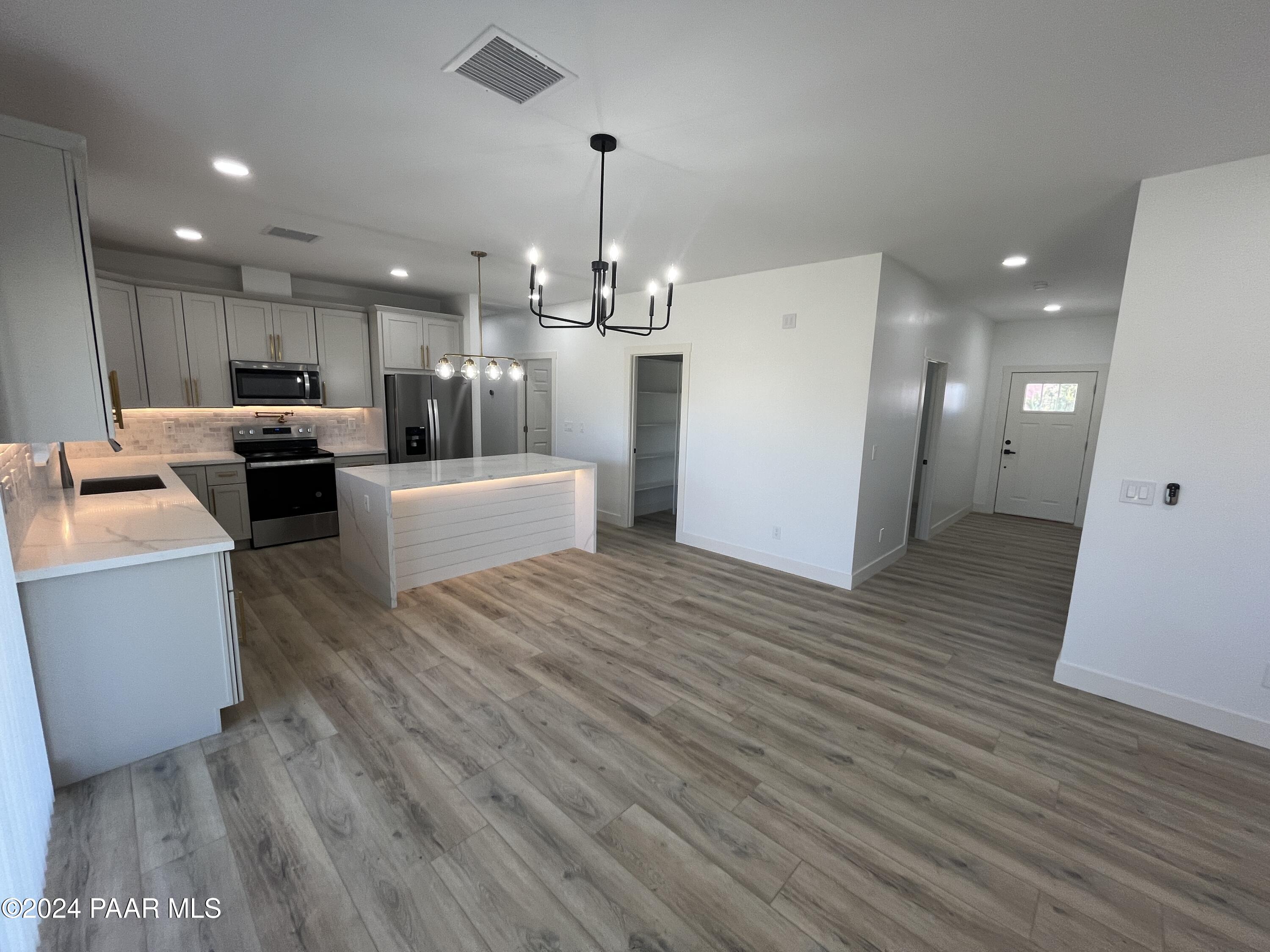 15630 Oasis Drive Mayer, AZ 86333 - Photo 17 of 29 a living room with hard wood floors and kitchen view