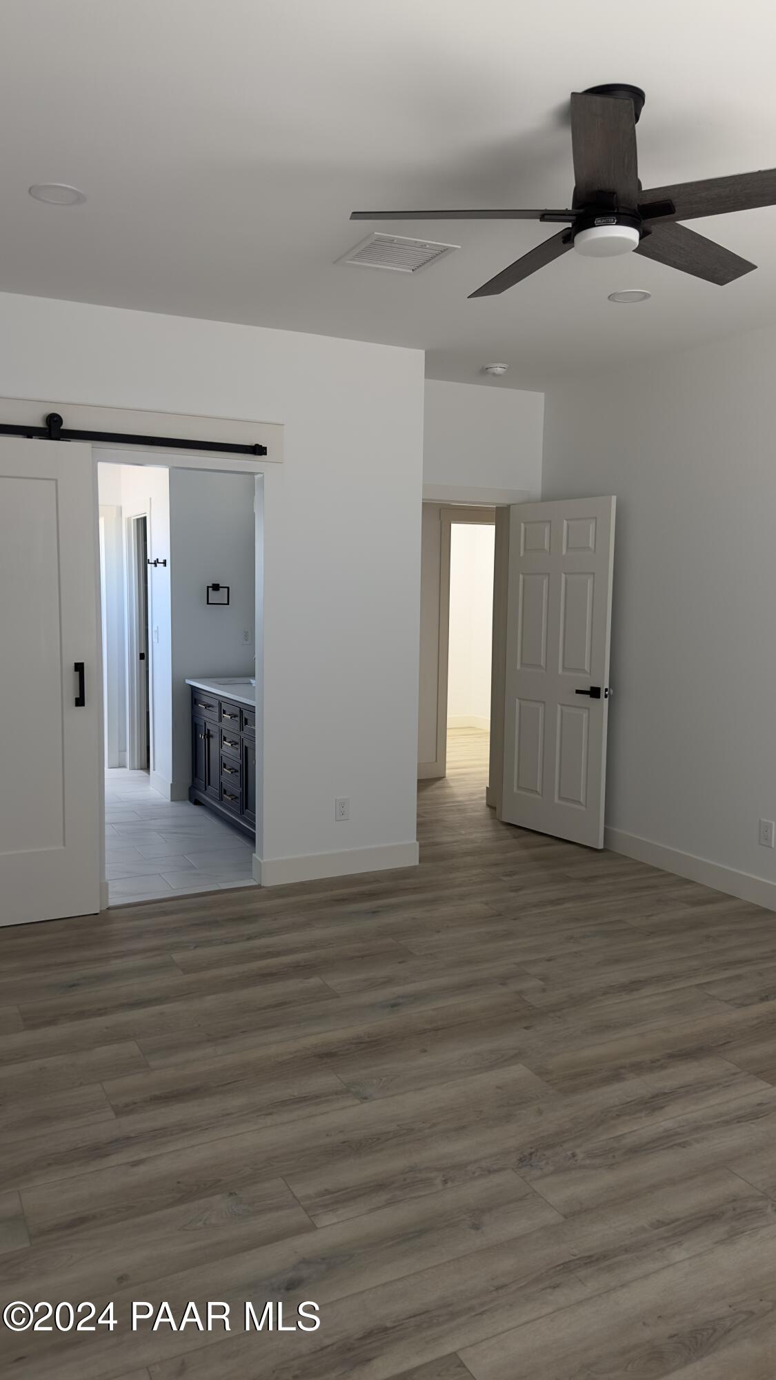 15630 Oasis Drive Mayer, AZ 86333 - Photo 23 of 29 a view of an empty room with wooden floor and a fireplace
