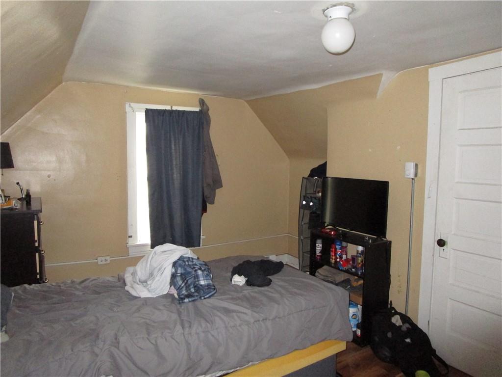 220 Mercer Street Butler, PA 16001 - Photo 12 of 12 a bedroom with a bed and a flat tv screen on a dresser