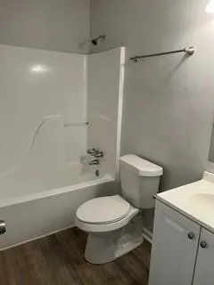 a white toilet sitting next to a bath tub