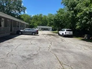a view of backyard with parked car