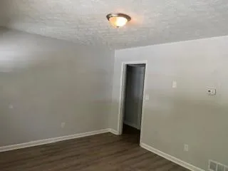 a view of a room with wooden floor