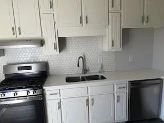 a kitchen with a sink and cabinets