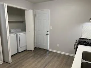 an empty room with wooden floor and closet